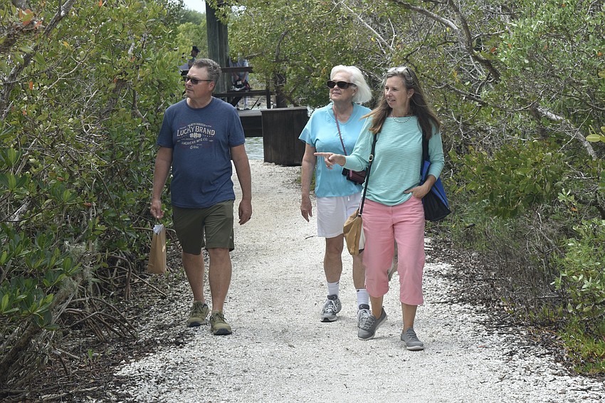 Keith Anderson, Janie Pratt and Lora Lyn Frederick take a walk down the trail. They came to view the area due to the Hammock Biome Restoration Project being pursued at Siesta Key Chapel.