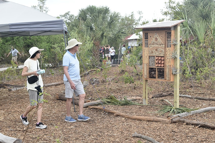 Tobi Schneider and Steve Newmeister look at the pollinator.