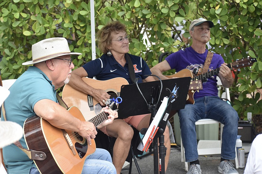 Mike Lawless, Elizabeth Muss and Michael Cohen perform with a driveway band that residents formed in The Landings.