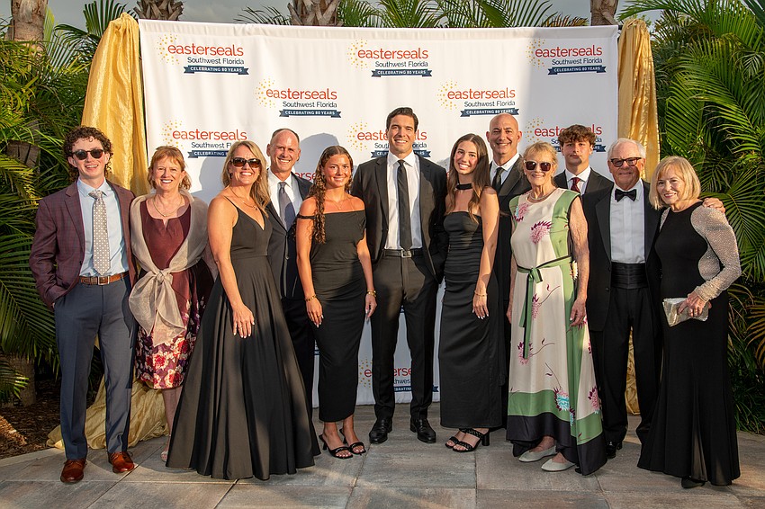 The Malcom family poses with Will Reeve, the evening's keynote speaker.