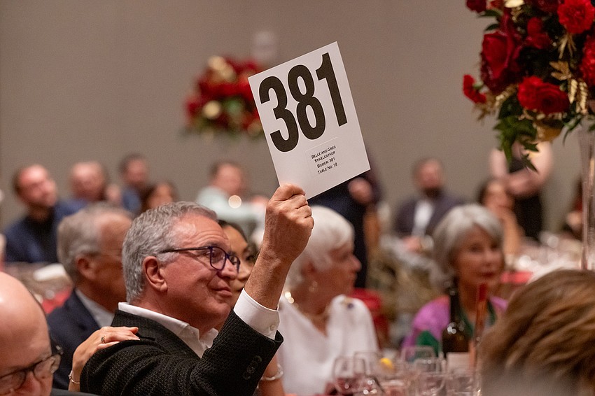 Greg Stikeleather raises his paddle to support Easterseals Southwest Florida.