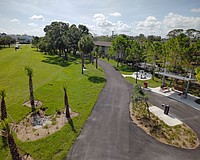 Sarasota's Alderman MURT includes a rest area with a shade shelter, drinking fountain, benches and tables, and a bike repair station as well as landscaping.  This view looks east, toward School Avenue.