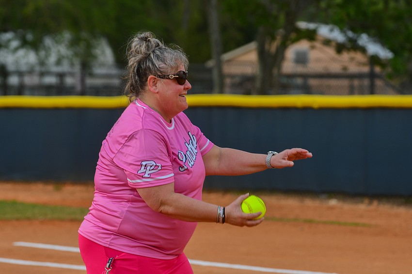 Dr. Phillips High softball team recognized DP teacher and breast cancer survivor Suzanne Scherfer during the team’s game dedicated as Strike Out Cancer Night. Scherfer was honored to throw the first pitch and be gifted a team jersey.