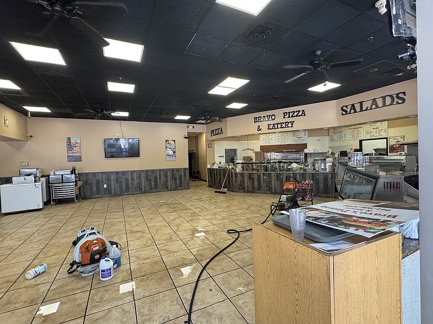 Cleaning crews are working to clear out the restaurant on March 31. Cleaning crews are working to clear out the restaurant on March 31.