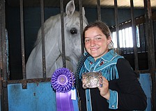 Myakka's Sydney McCullough shows off the first place ribbon and belt buckle she won in January for whip cracking in the senior division at the Manatee County Fair.
