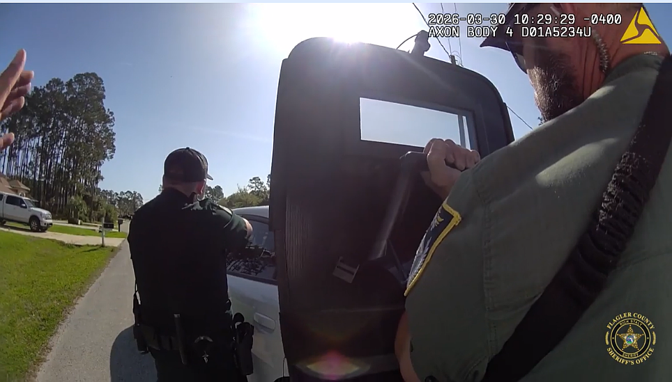 Screenshot from deputy body camera footage shows law enforcement responding to an armed standoff in Palm Coast.