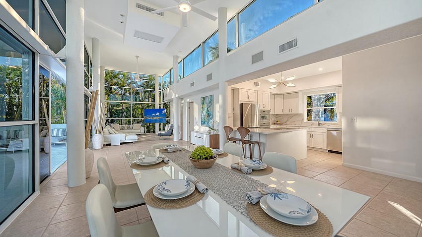 The home’s living area boasts a state-of-the-art kitchen and soaring windows on all four sides.