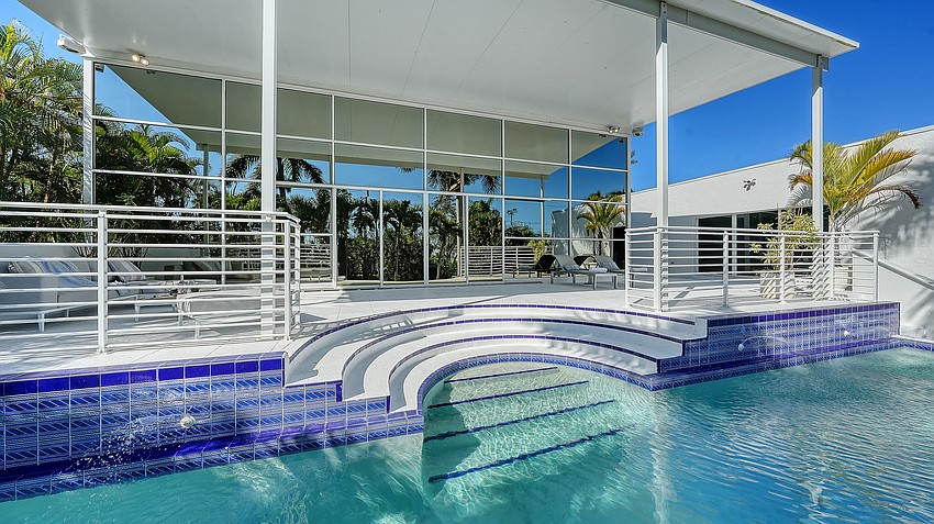 The lounging area in the 50-foot-long swimming pool adds some unexpected curves to the home’s design.