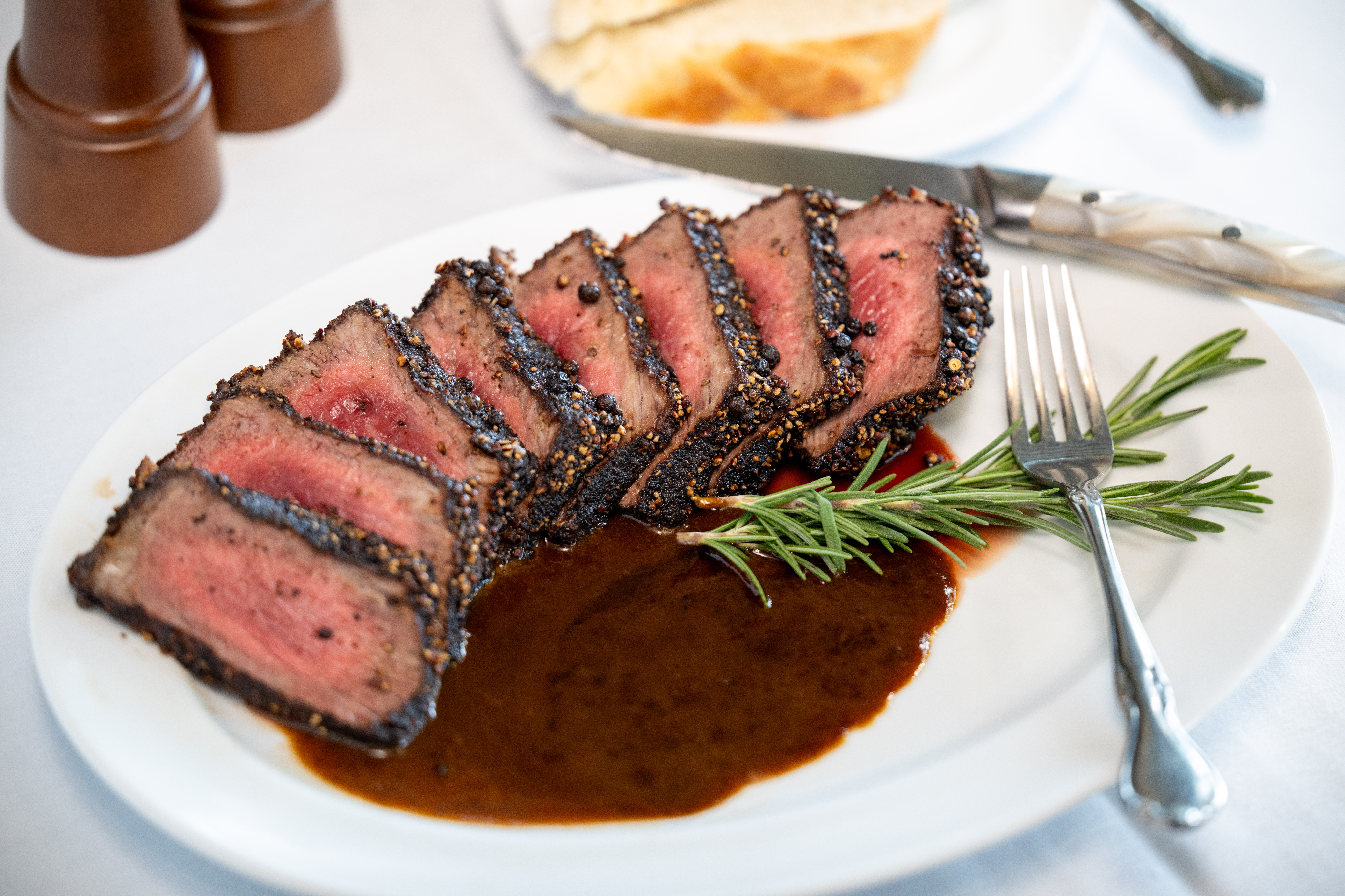 Euphemia Haye’s prime pepper steak arrives coated in freshly cracked pepper and finished with a rich steak sauce, reflecting nearly five decades of classic technique and tableside tradition.