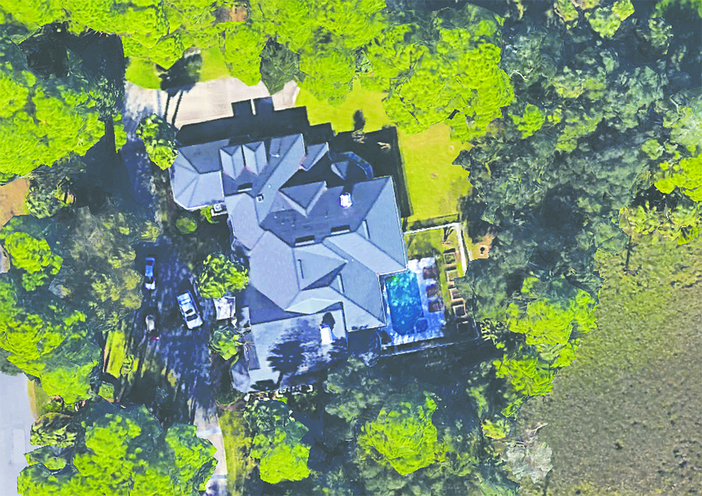 Two-story home with golf views in Marsh Landing features five bedrooms, six full bathrooms, one half bathroom, porches, a patio, a pool and guest suite.