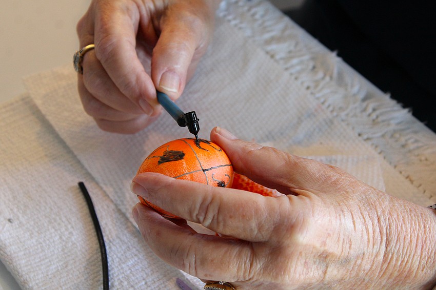 The fine-point kistky allows pysanky artists to create intricate designs with melted beeswax, which they layer to make a layered pattern with dyes.