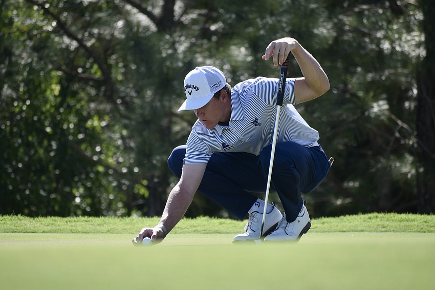 Barend Botha places his ball before a putt on the third green. The 24-year-old South African finished two over par, but was outside the top 100.