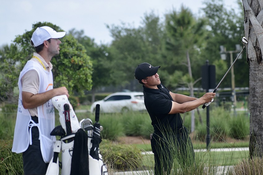 Cameron Champ (right) watches his out-of-bounds shot head toward the ninth green. He has three PGA Tour wins in his career, but is tied for 39th place entering day three.