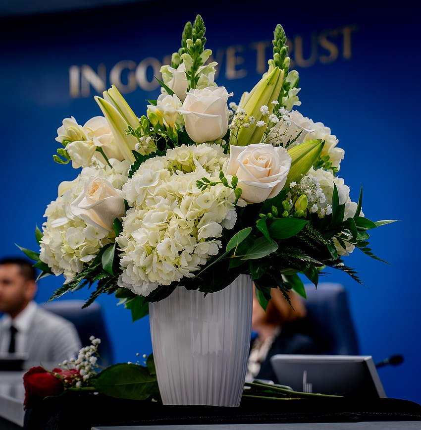 Since Commissioner Carol Felts died Feb. 24, flowers and a black sash have been left in her place. Since Commissioner Carol Felts died Feb. 24, flowers and a black sash have been left in her place.