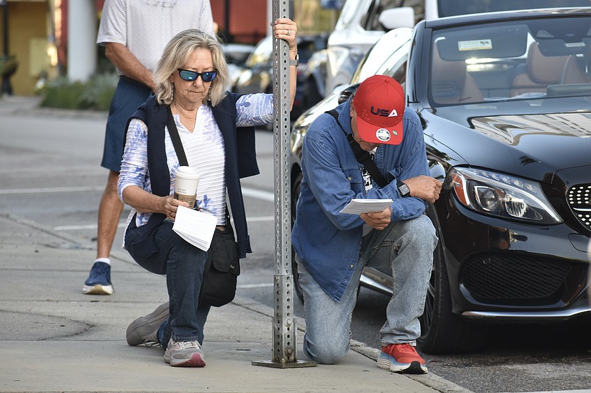 Donna and Paul Rutledge kneel at a station.