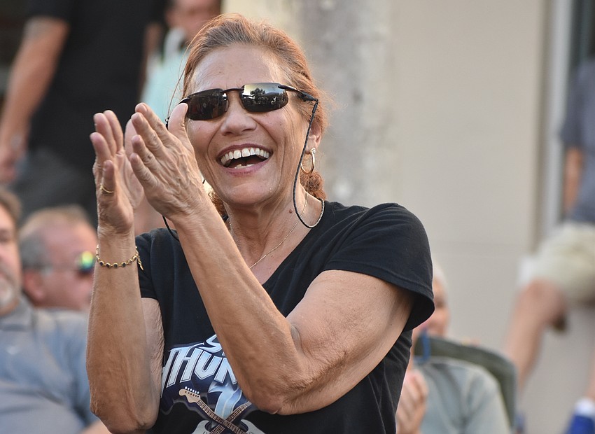 Jeri Parrish, who is from Southwest Ranches, applauds during Silver Thunder's performance at Music on Main April 3.