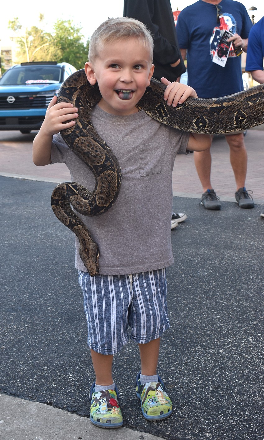 Lakewood Ranch's Hunter Watts holds a 14-year-old boa constrictor from Bugz Rule.