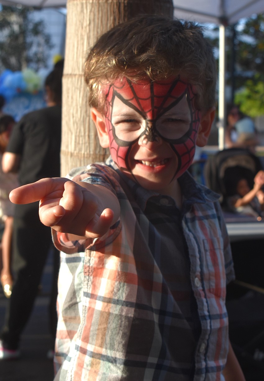 Three-year-old Alex Ryan, who is visiting from Rochester, New York,  channels his inner Spider-Man at Music on Main.