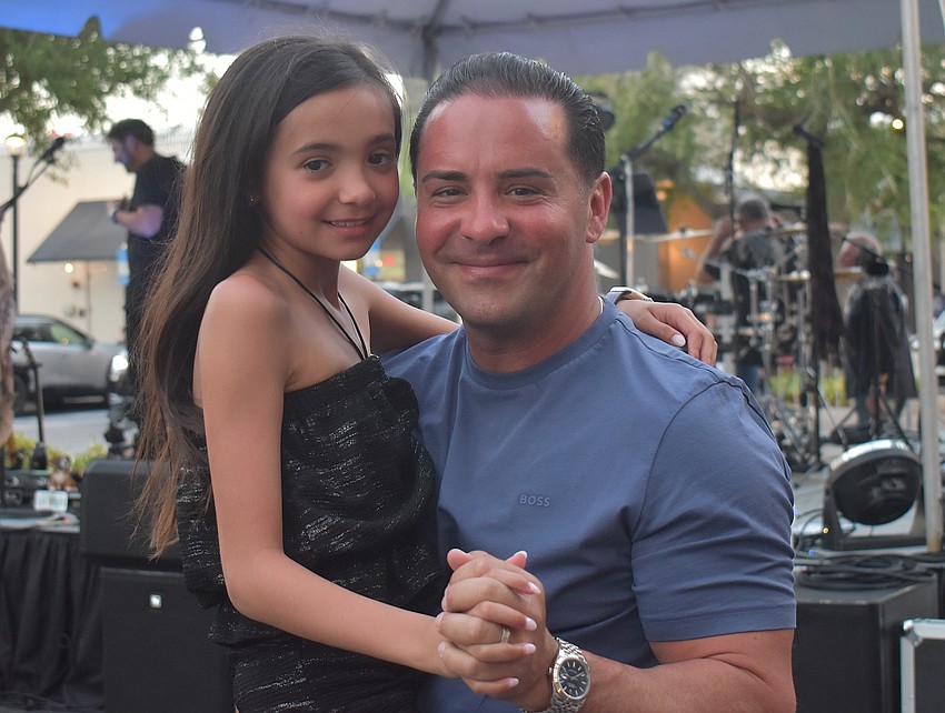 Nicolette Difiglia and her dad Peter, both of Star Farms, dance together at Music on Main April 3.