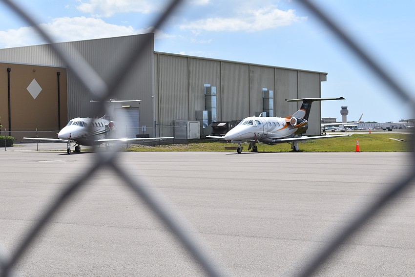 Airplanes park just beyond the school's fence at the Sarasota Bradenton International Airport.
