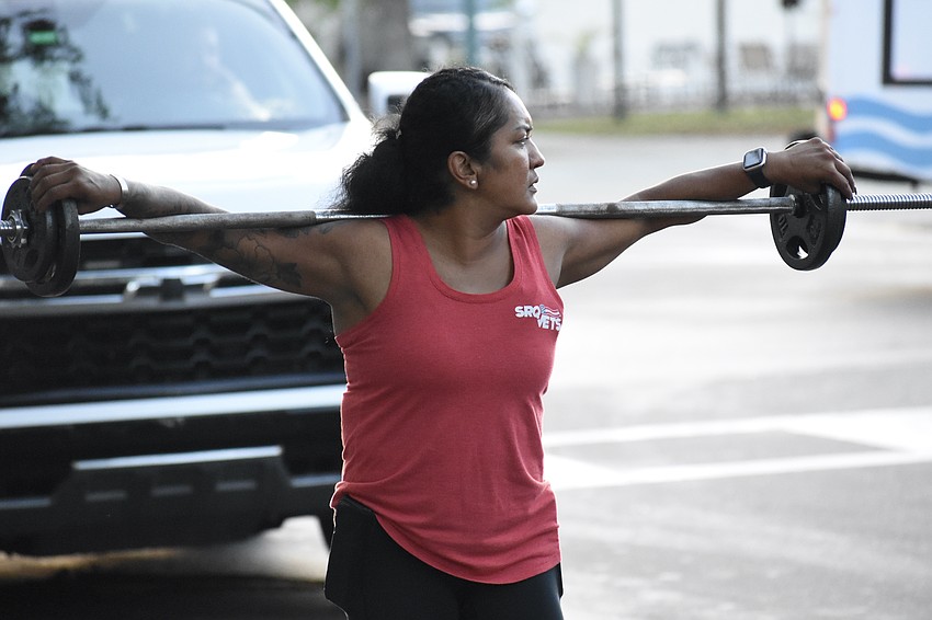 Maria Guardado-Villagran carries the weight of the cross with her.