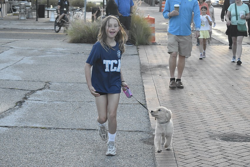 Taylor Lodge, 8, runs with Abby.