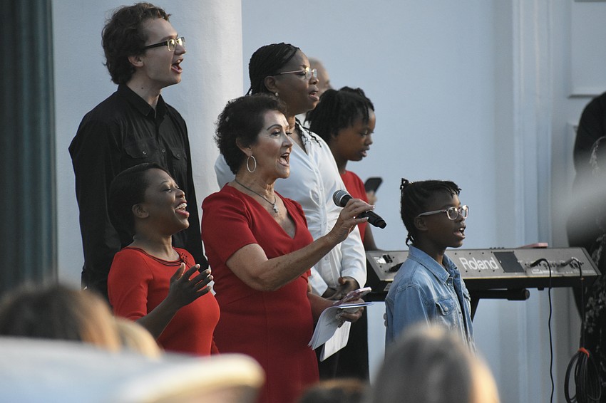 Timothy Abramov, Christiana Victor, Elyse Byler, Rose Prophete, Grace Prophete and Joy Prophete sing along to music led by Sara Wright (not pictured) at First Sarasota Church.