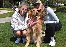 Angelina Goesch and her mom, Ana Goesch, founder of Dogs of Lakewood Ranch, pose with Ana's 4-year-old Golden retriever, Maple.