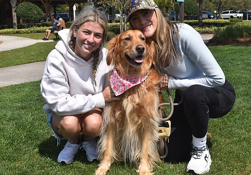 Angelina Goesch and her mom, Ana Goesch, founder of Dogs of Lakewood Ranch, pose with Ana's 4-year-old Golden retriever, Maple.