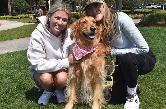 Angelina Goesch and her mom, Ana Goesch, founder of Dogs of Lakewood Ranch, pose with Ana's 4-year-old Golden retriever, Maple.