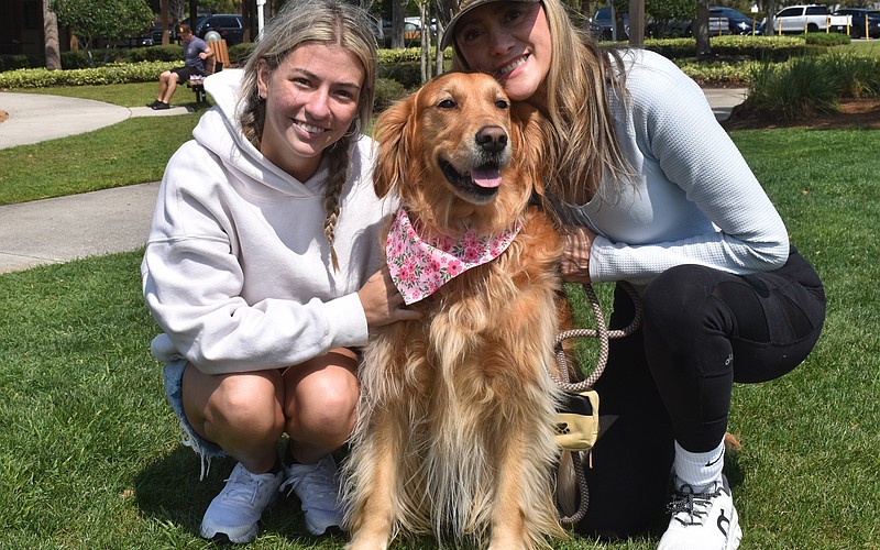 Angelina Goesch and her mom, Ana Goesch, founder of Dogs of Lakewood Ranch, pose with Ana's 4-year-old Golden retriever, Maple.