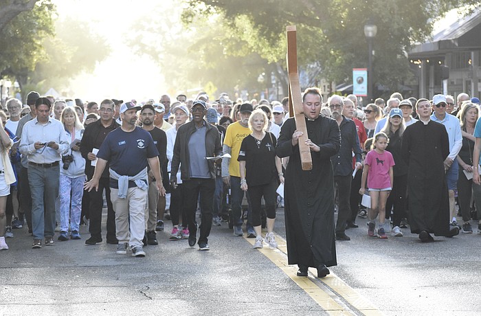 Rev. Mason Waldhauser, associate rector for adult formation at Church of the Redeemer, leads the walk.