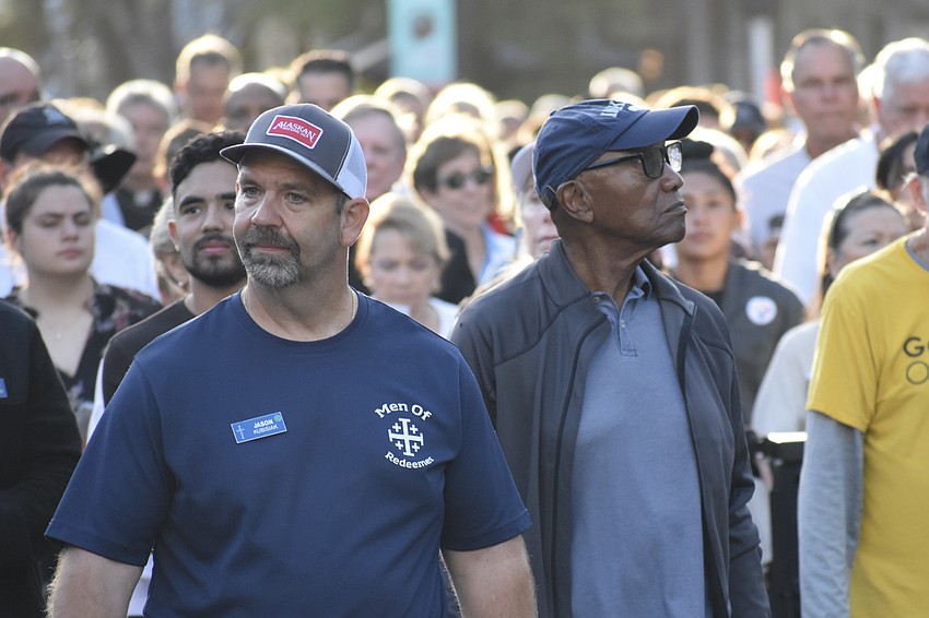 Jason Kubisiak and Willie Clemons walk at the front of the procession.