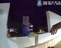 Screenshot of a body-worn camera video shows the moment SPD Officer Michal Banasiak reaches for a bottle before grabbing the man in distress and pulling him to safety.and