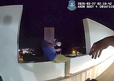 Screenshot of a body-worn camera video shows the moment SPD Officer Michal Banasiak reaches for a bottle before grabbing the man in distress and pulling him to safety.and