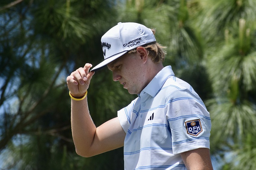 Ian Gilligan adjusts his hat while walking the first-hole fairway. He led by four strokes after the second round, but has since fallen into a tie with Jeremy Gandon.