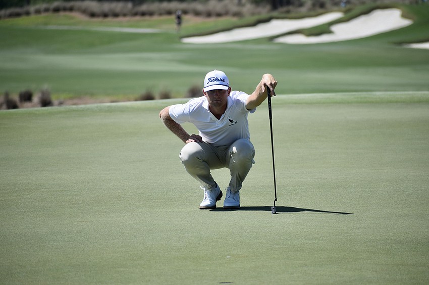 Samuel Anderson reads the 11th green before attempting a putt. He shot two over par in the third round and is 14 strokes behind the leaders.