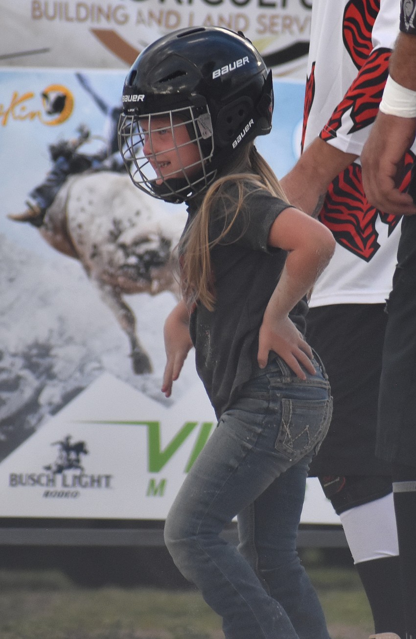 Riley Mixon, who stayed on a sheep for 1.8 seconds, walks away after her turn in the mutton busting event at the Dakin Dairy Farms' Easter Bull Bash April 4.