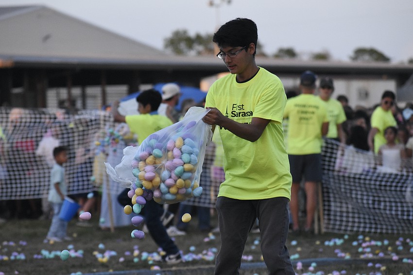 Volunteer Isaac Chavez-Santiago helps prepare an egg hunt.