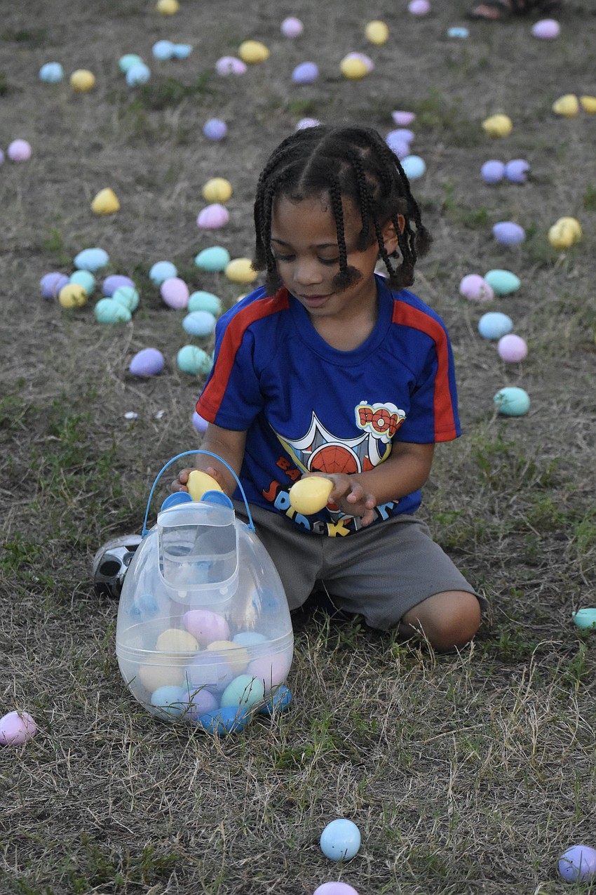 Zaden Daniels, 5, sorts through some eggs.