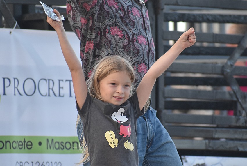 Callie Moseley wins the mutton busting competition by holding on to the sheep for 14.68 seconds.