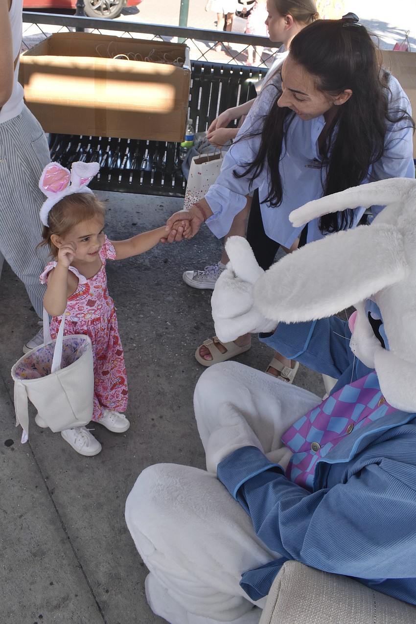 Evie Holwerda, 2, and her mother Jesse Holwerda meet the Easter Bunny.
