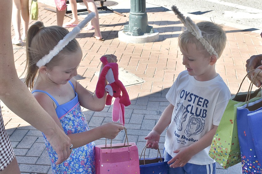 Weslie DeMarchi, 6, and Pace DeMarchi, 4, look over their gifts.