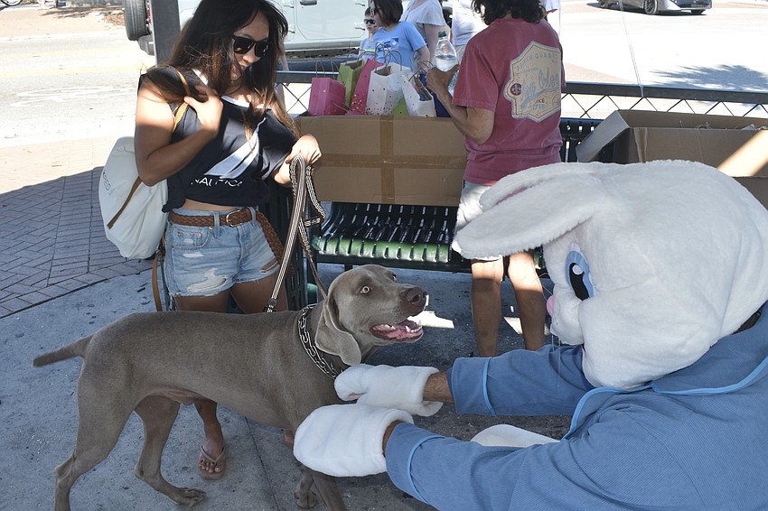 Guinivere Nguyen introduces her dog Duke to the Easter Bunny.