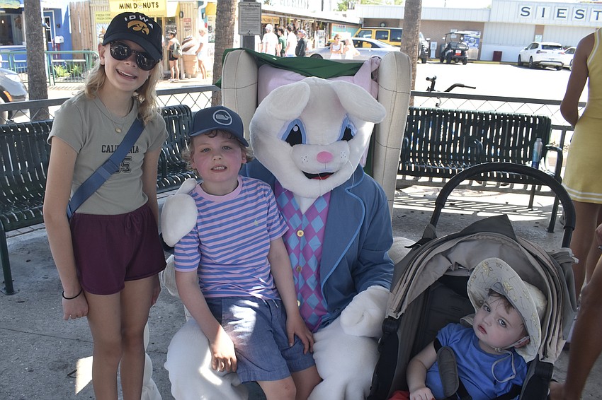 Cecilia Speidel, 11, Mikey Hyland, 6, and Brice Hyland, 2, meet the Easter Bunny.