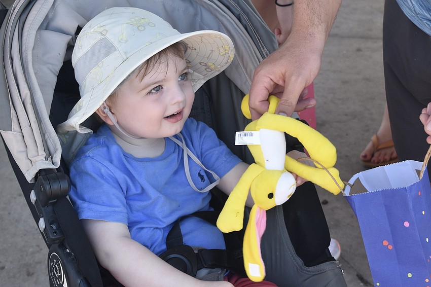 Brice Hyland, 2, likes the contents of his gift bags.