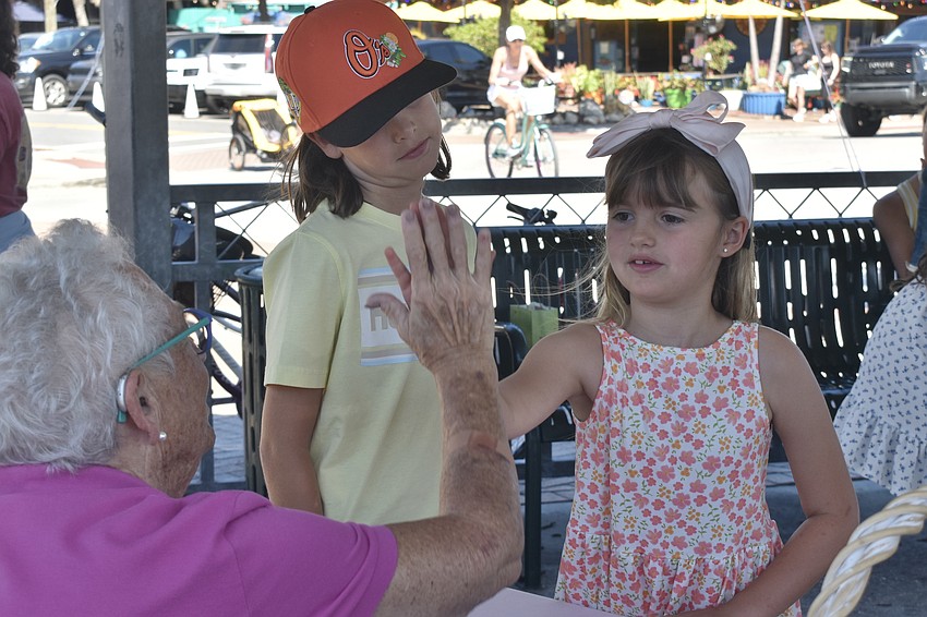 Annie Harman talks with Jack Dunteman, 9, and Isabella Dunteman, 7.