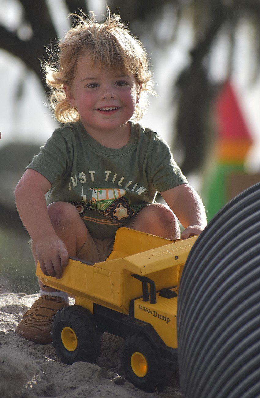 Sarasota's Jayden Peirce, 3,  plays with a truck on top of a sand pile at Dakin Dairy Farms.