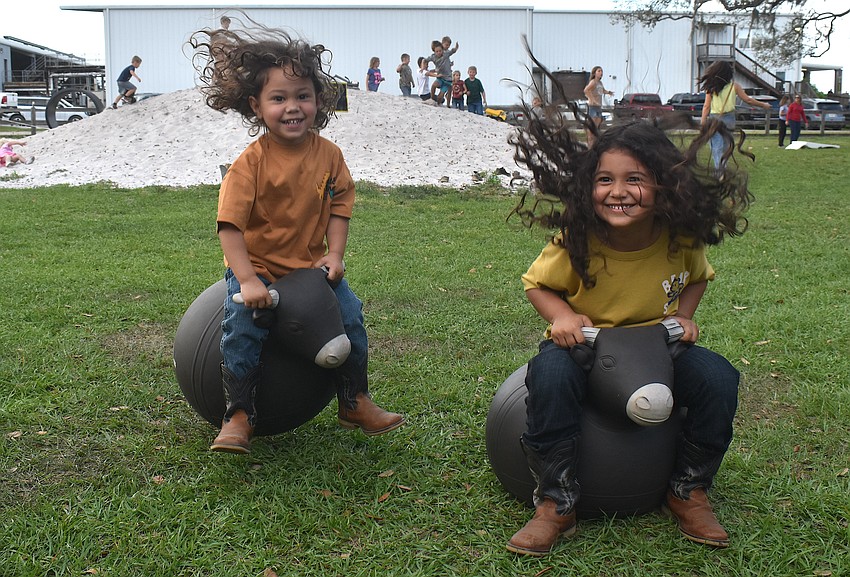 Bradenton's Zeyden Quiming-Delgado, 3, and Zyriel Quiming-Delgado, 4, try their bull riding skills at Dakin Dairy Farms.