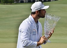 Jeremy Gandon kisses the LECOM Suncoast Classic trophy. He shot six under par in the final round to win the title at 22 under par overall, defeating Mitchell Meissner and Jay Card III by one stroke.